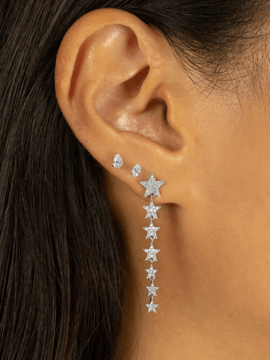 Oval diamond studs paired with pear diamond studs and diamond star dangle earring