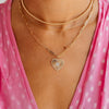 14K gold paperclip chain necklace with diamond heart pendant layered with dainty gold paperclip chain and gold beaded choker