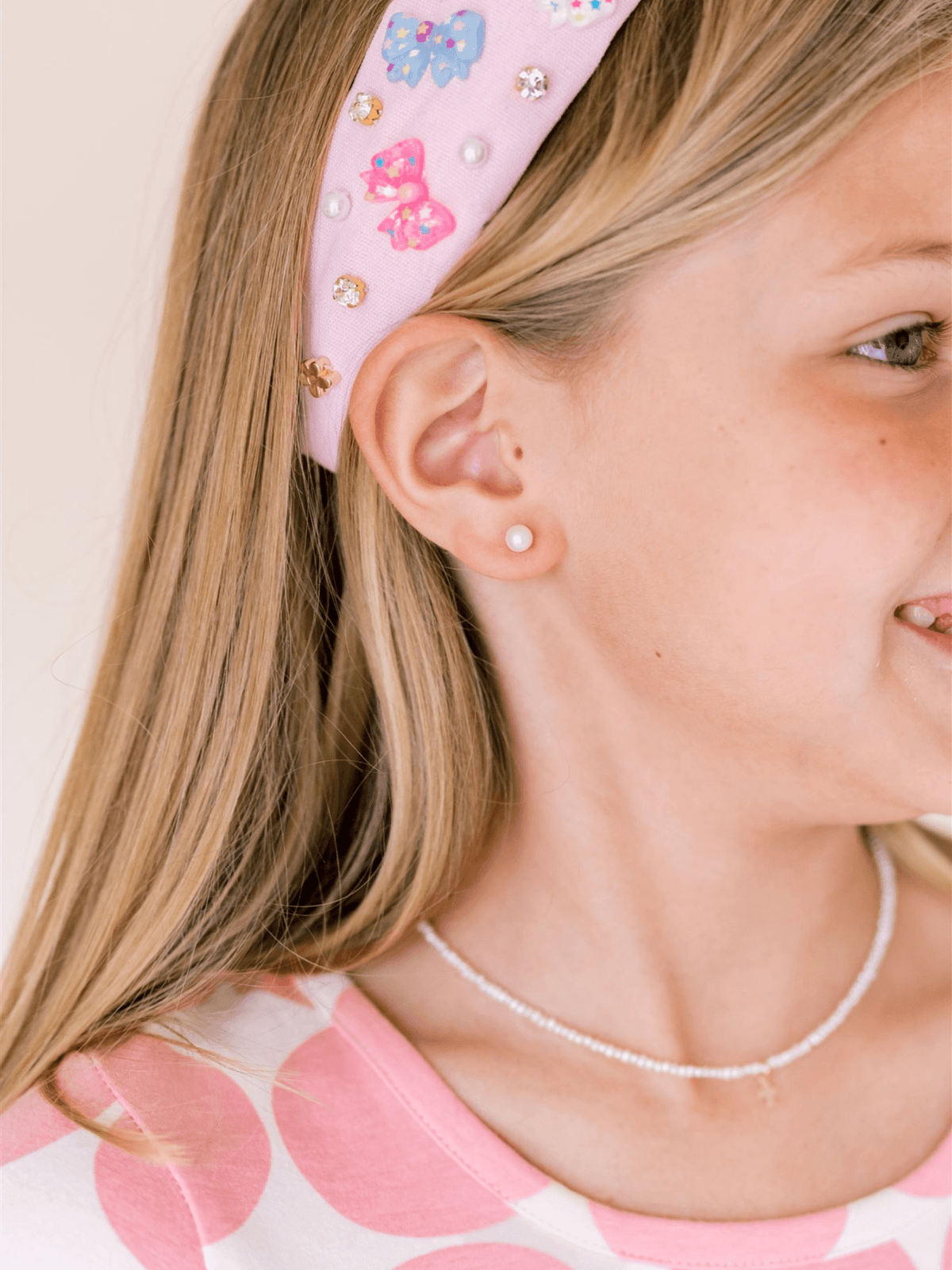 Pearl stud earring on model ear