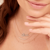 14K gold diamond name charm on dainty gold chain layered with white gold diamond chasing necklace and diamond drop layering necklace in yellow gold