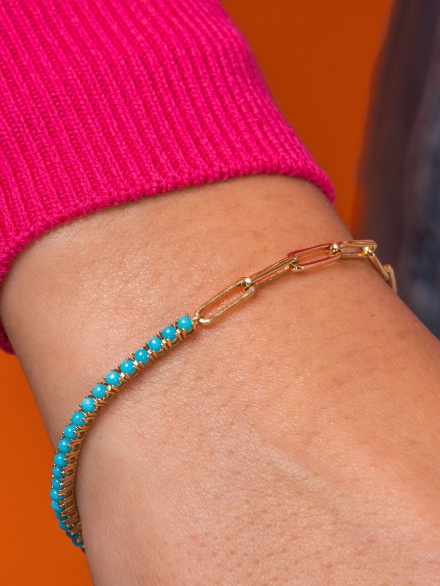 14K yellow gold half paperclip chain half turquoise tennis bracelet on white background