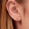 Tiny diamond stud earring paired with diamond trio stud