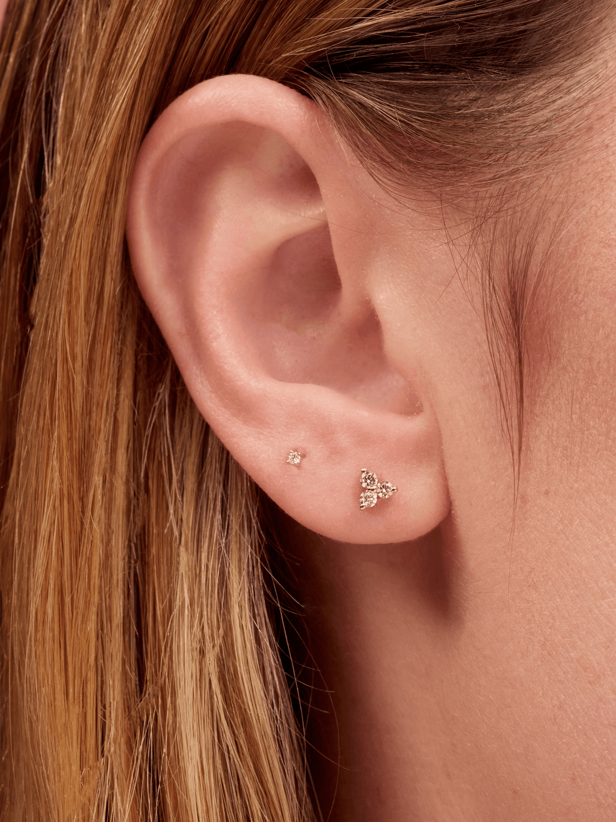 Tiny diamond stud earring paired with diamond trio stud