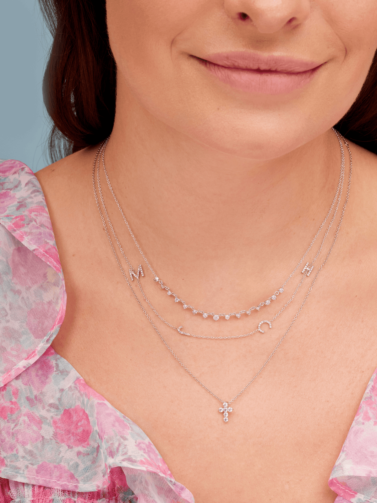 White Gold 4 Diamond Initial Necklace Layered on Neck with Diamond Cross Necklace and Graduated Diamond Chain Necklace