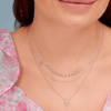 Dainty white gold chain with four diamond initial charms layered with dainty white gold diamond cross necklace and white gold diamond layering necklace