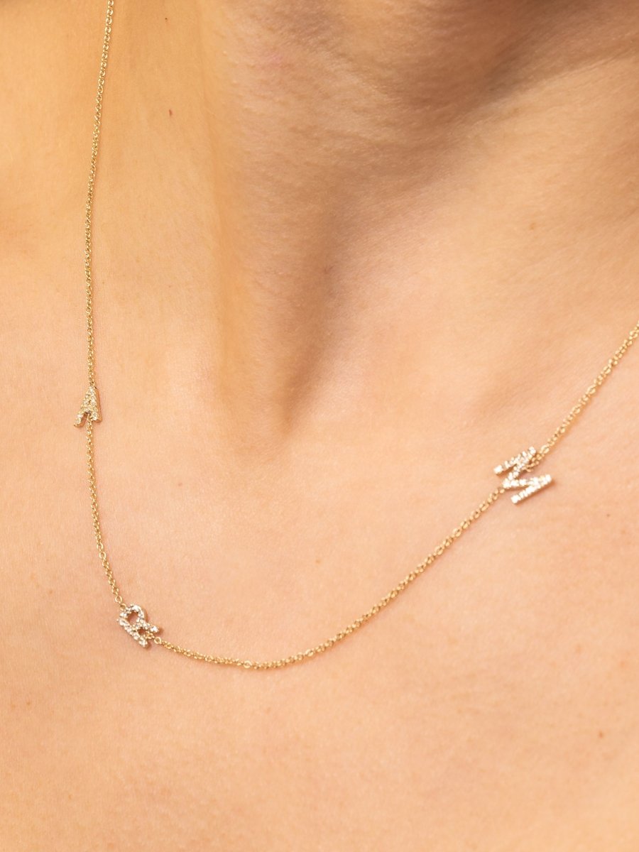 Dainty yellow gold chain with three diamond initials
