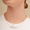14K gold diamond name charm on dainty gold chain layered with gold paperclip necklace and dainty gold chain with diamond heart