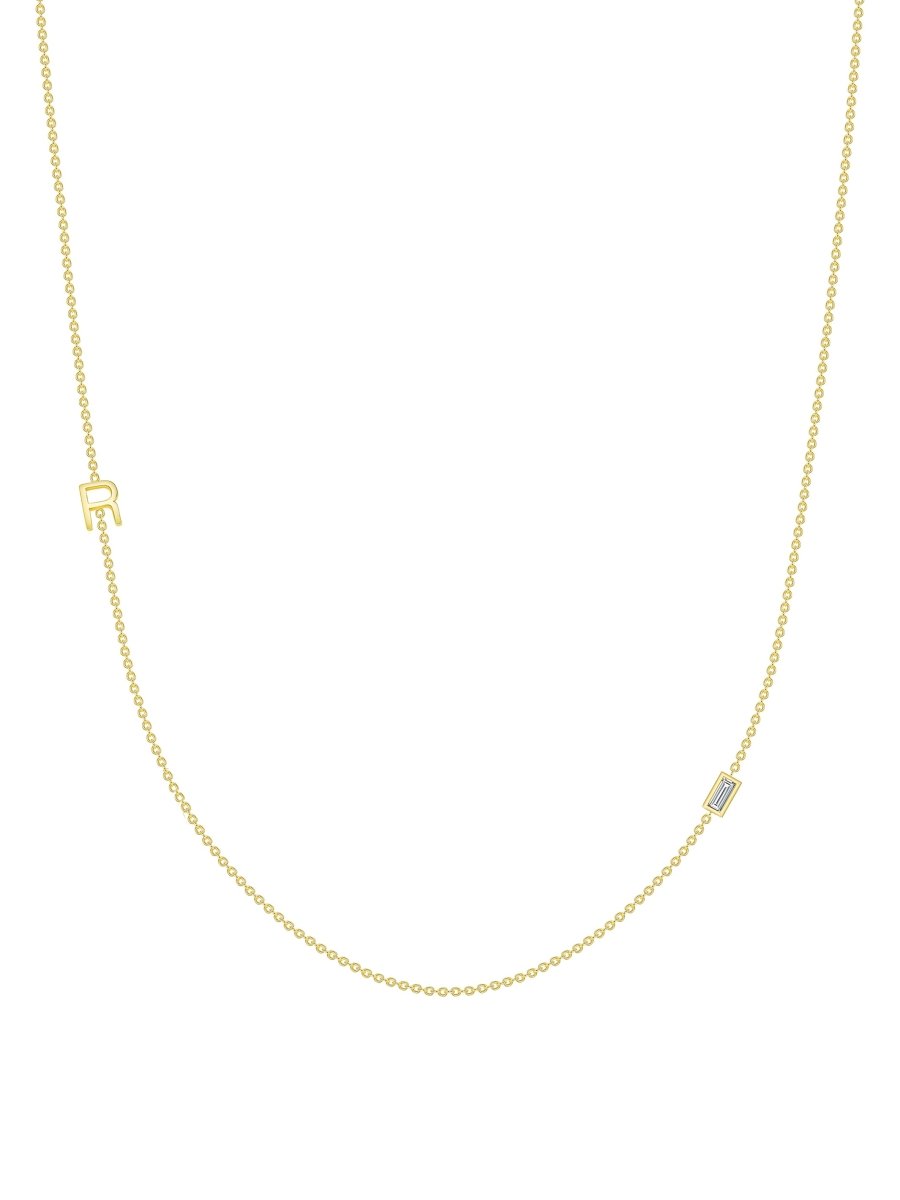 yellow gold single initial chain necklace with baguette diamond on white background