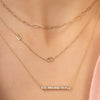 Dainty gold chain with two initial letters layered with gold paperclip chain necklace and baguette diamond bar necklace