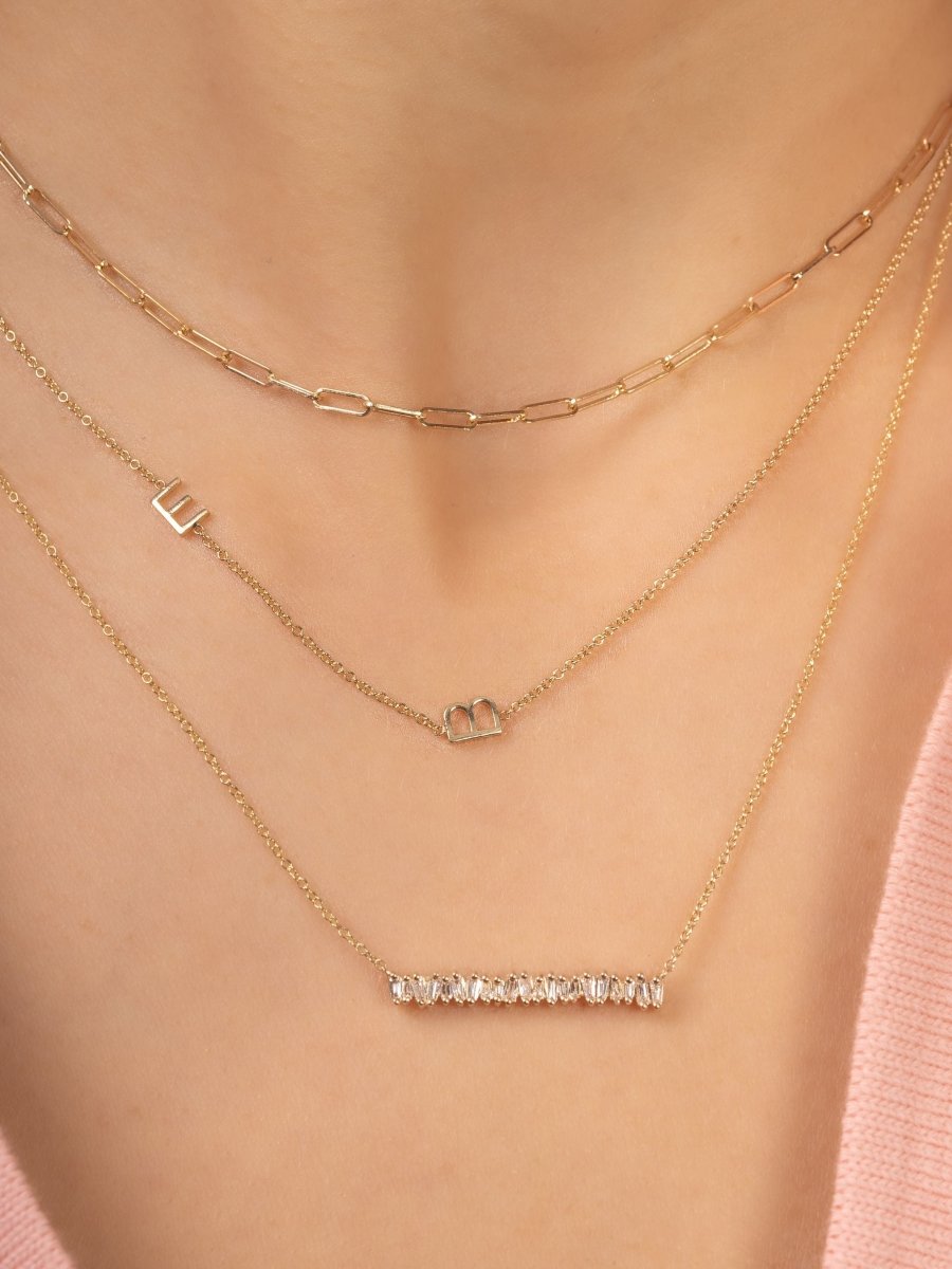 Dainty gold chain with two initial letters layered with gold paperclip chain necklace and baguette diamond bar necklace