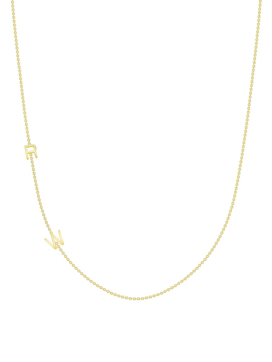 yellow gold single initial chain necklace with baguette diamond on a white background