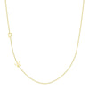 yellow gold single initial chain necklace with baguette diamond on a white background