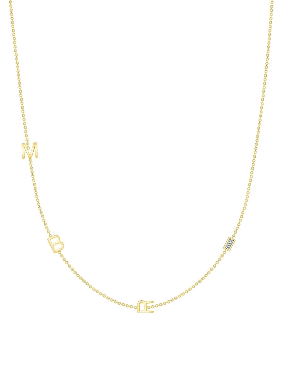 yellow gold triple initial chain necklace with baguette diamond on white background