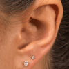 Tiny diamond earring paired with pear diamond stud