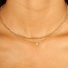 3 stone diamond necklace layered with gold beaded choker