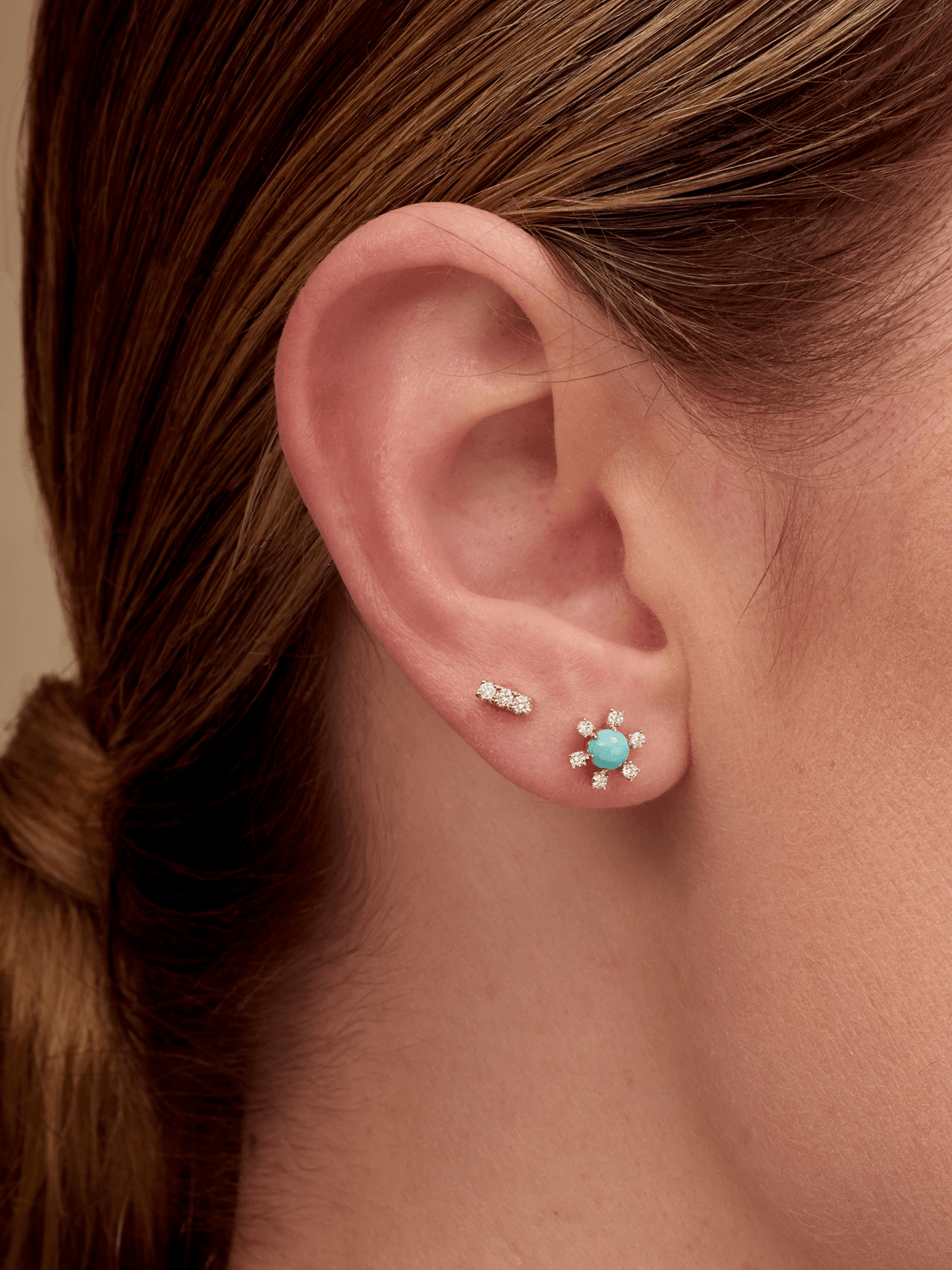 Turquoise earrings paired with diamond bar studs